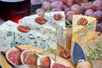 Assorted types of cheese on a wooden board