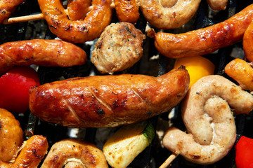 Assorted types of meat and vegetables on the grill
