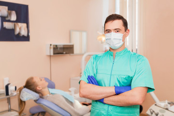 Fototapeta na wymiar Dentist in a mask in his office