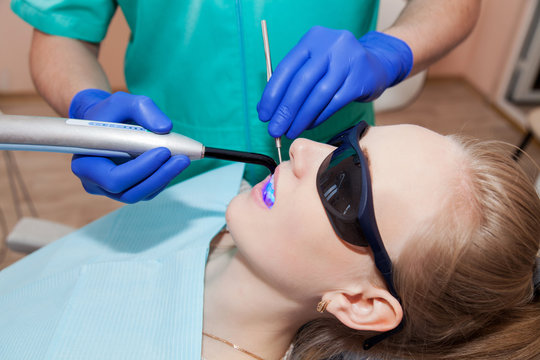 Dentist working with ultraviolet lamp