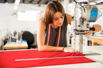 Fashion designer cutting fabric