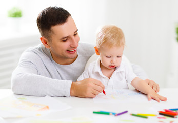 father and baby son paint together
