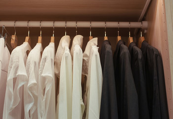 White and black shirts on trempele in the closet