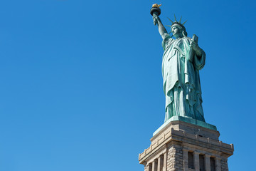 Obraz premium Statue of Liberty on clear blue sky in a sunny day, low angle view with clipping path