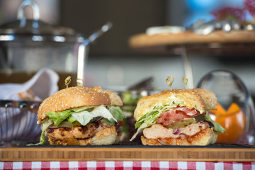 Fresh homemade burgers on wooden board in a restaurant