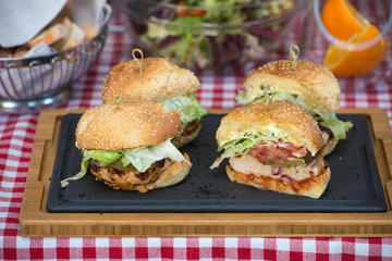 Fresh homemade burgers on wooden board in a restaurant