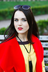 beautiful elegant woman on the street looks into the frame.