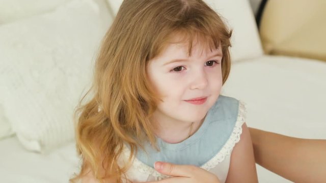 mom straightens hair daughter two years