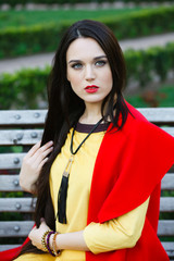 beautiful elegant woman on the street looks into the frame.