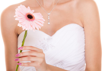 Obraz na płótnie Canvas Closeup of bride white wedding dress with flower