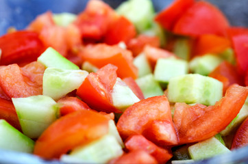 Sliced cucumbers and tomatoes close up.