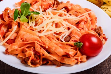 Meat paste. Tagliatelle with beef, pork and tomatoes