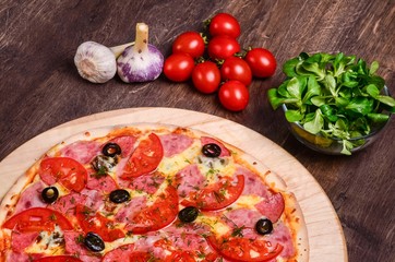 Thin pizza with ham and tomatoes