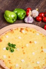 Thin pizza with cheese. Four types of cheese
