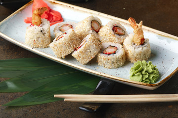 Sushi Roll with fish in a beautiful blue plate.