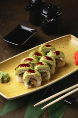 Sushi Roll with fish in a beautiful blue plate.