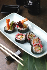 Sushi Roll with fish in a beautiful blue plate.