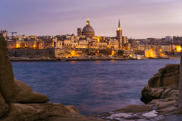 Valletta seafront at sunset with Basilica of Our Lady of Mount Carmel, viewed from Sliema, Malta