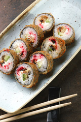 Sushi Roll with fish in a beautiful blue plate.