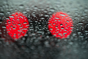 Abstract background for the banner. Two night lights of city transport were seen through the windshield in rainy weather. Concept of threat, danger, hazard, peril