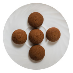 Chocolate cookie on the saucer from above isolated on white background