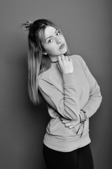 Fototapeta premium Young brunette lady posing on grey background