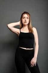 Fototapeta premium Young brunette lady posing on grey background