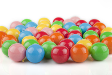 Multicolored gumballs on a white surface. Bubble gums isolated on white background.