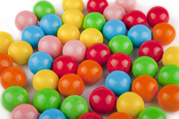 Fototapeta na wymiar Multicolored gumballs on a white surface. Bubble gums isolated on white background.