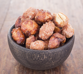 sugared peanuts on the wooden background