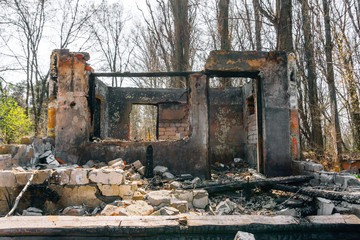 Fototapeta na wymiar Ruined and burnt house, scattered bricks