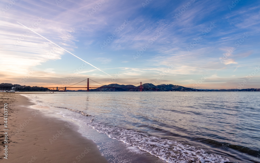 Sticker Beach and Golden Gate Bridge at sunset - San Francisco, California, USA