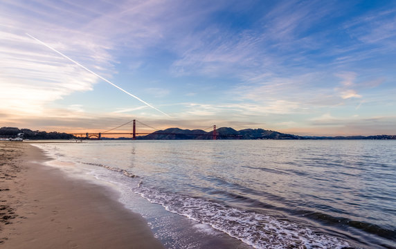Beach and Golden Gate Bridge at sunset - San Francisco, California, USA