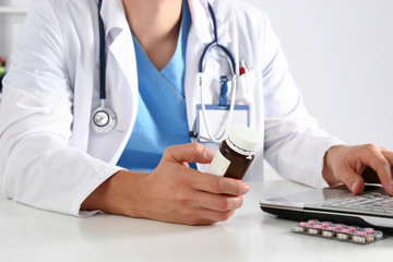 Hand of doctors holding many different pills