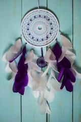 Dreamcatcher made of feathers, leather, beads, and ropes