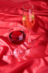 Two Glass of red, white wine on red background