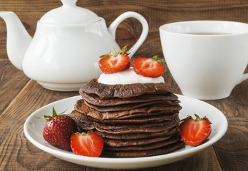 Chocolate pancakes with strawberries