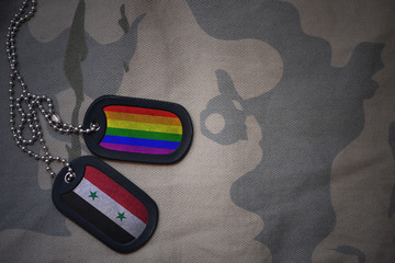 army blank, dog tag with flag of syria and gay rainbow flag on the khaki texture background....