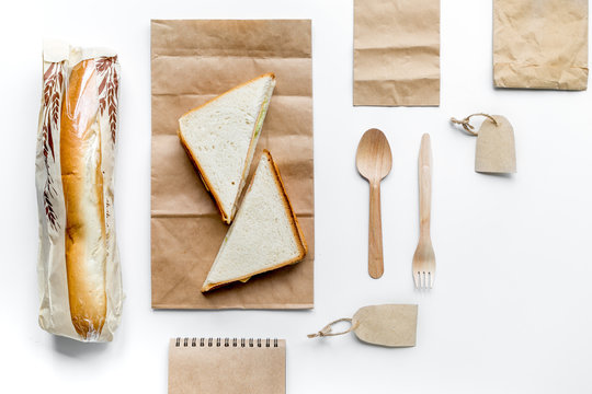 Delivery Set With Paper Bags And Sandwich On White Background Top View Mockup