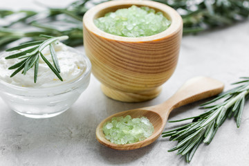 Rosemary body cream in glass bowl in cosmetic set on table background
