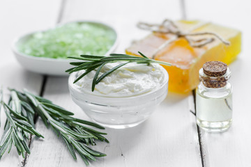 organic cosmetics with rosemary extract on wooden table background
