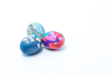 Three easter eggs hand painted in home - abstract colors dark blue, pink, rosa, white, purple - isolated in white background