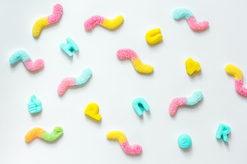 Delicious sugar lollipops on white background top view pattern