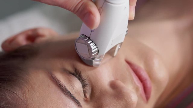 Close up facial LPG vacuum massage therapy. Woman getting facial rejuvenate therapy. Hardware cosmetology