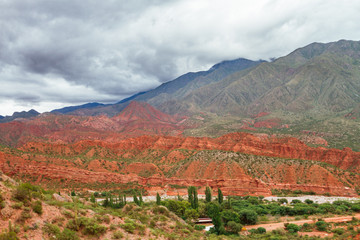Fototapeta premium Valley with shrubs among red hills in La Rioja, Argentina