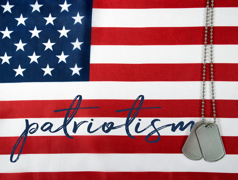 word patriotism and military dog tags on American flag