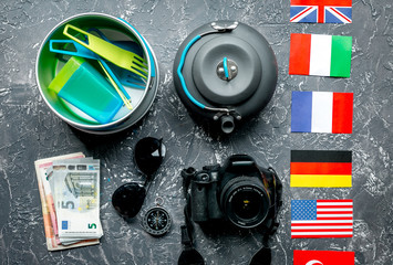 Traveler's accessories in vacation concept on gray table background top view
