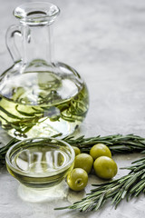 Obraz na płótnie Canvas jar with oil with olives on stone table background