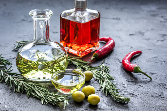 olive and chili oil with ingredients on kitchen table background
