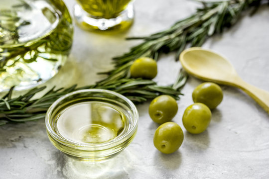 olive oil with ingredients on kitchen table background